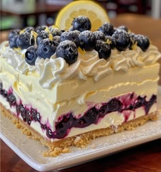 a piece of cake with blueberries and lemon on top