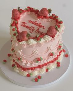 a heart shaped cake with strawberries on top and the words happy birthday to you