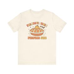 This natural Thanksgiving t-shirt features a retro illustration of a pumpkin pie and the lettering 'thankful vibes and pumpkin pies'. It exudes a cozy, festive vibe and is perfect for Thanksgiving celebrations. The unisex design makes it suitable for anyone looking to show gratitude and enjoy the holiday spirit. Product features - Side seams for structural support - Ribbed knit collar for elasticity - Shoulder tape for stability - Made with 100% lightweight cotton Retro Fall T-shirt With Funny Print, Vintage Graphic Print T-shirt For Fall, Thanksgiving Graphic Print Crew Neck T-shirt, Casual Thanksgiving T-shirt With Graphic Print, Casual Thanksgiving Graphic T-shirt, Casual Thanksgiving Graphic Print T-shirt, Thanksgiving Cotton T-shirt With Crew Neck, Cotton Crew Neck T-shirt For Thanksgiving, Thanksgiving Cotton T-shirt With Graphic Print