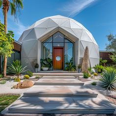 a large dome house with steps leading up to the front door and entry way, surrounded by palm trees