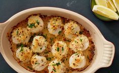 a casserole dish with scallops and parmesan cheese