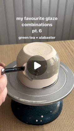 a person is using a pen to draw on a tea pot with the words my favorite glaze combinations pt 6 green tea + albaster