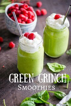 two green smoothies with whipped cream and raspberries