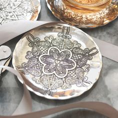 decorative plates and utensils are sitting on a table with silver ribbon around them