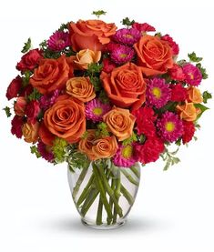 a vase filled with orange and pink flowers