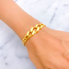 This 22k gold bracelet, weighing 9.6 grams, features a polished and brilliant design that exudes elegance and sophistication. The yellow gold finish enhances its luxurious and radiant appearance. Measuring 8.1 inches in length with an additional 1 inch of adjustable links, this bracelet is secured with a lobster lock for added safety and convenience. Ideal for those who appreciate refined beauty and exquisite craftsmanship, this stunning bracelet is a standout addition to any jewelry collection. Gold-plated Cuban Link Bracelet, Formal Gold Cuban Link Bracelet With Adjustable Chain, Formal 22k Yellow Gold Chain Bracelet, Gold Plated Bangle Bracelet With Solid Link, Gold-plated Bangle Bracelet, Gold-plated Bangle Bracelet With Gold Chain, Adjustable Cuban Link Bracelet In Yellow Gold Plated, Gold Plated Bangle Bracelet With Gold Chain, Formal 22k Gold Bracelets