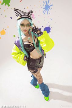 a woman with blue hair and green eyes is dressed in punk clothing while holding an umbrella