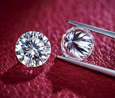 a pair of diamonds sitting on top of a red surface