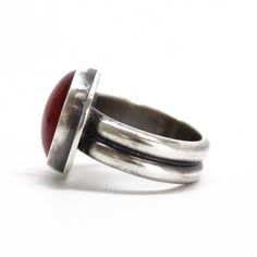 This ring will capture your heart at first sight with it's bright red glow! I have bezel set this round Rosarita stone in a handmade sterling silver setting. The band is a double wide dome which offers a super comfortable fit. The silver has been antiqued and polished for added depth a beauty.Genuine RosaritaSize 7 US this ring can not be resized925 Sterling SilverThe face of the ring is about 5/8" W and the band is about 1/4" WStamped 925 inside the bandArtisan made in Texas, USAArrives thought Red Domed Gemstone Rings, Red Domed Rings For Anniversary, Red Domed Anniversary Ring, Classic Adjustable Red Ring, Red Gemstone Dome Ring, Red Oxidized Finish Round Jewelry, Red Oxidized Finish Jewelry, Red Sterling Silver Oval Cabochon Ring, Vintage Red Jewelry With Bezel Setting