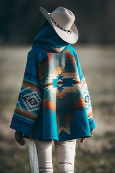 Made famous by the fictional character Beth Dutton on the show Yellowstone. Fully lined bell-shaped hooded cloak with welt patch pockets and three toggle closure. Unnapped Pendleton blankets: 82% Wool, 18% Cotton. Wool Cashmere facings and Silk Rayon peachskin lining. Valentine is 5'11" and wears size OS. Charlotte is 5'10" and wears size OS. Launched into ethereal aquamarine. The eye of the sapphire. For the woman deep of heart and inspired by the goodness in people. Their authentic yearning. L Pendleton Blankets, Yellowstone Series, Pendleton Blanket, Pagosa Springs, Beth Dutton, Hooded Cloak, Blanket Designs, Cloak, The Eye