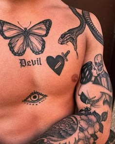 a man with tattoos on his chest and arm