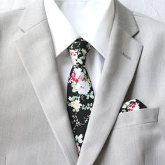 An upbeat floral pattern adds an instant lightheartedness to any event, and our bow tie is guaranteed to liven up your look. Tie Mood adult bow ties are double-deck (two layers), have a sturdy loop and clasp to ensure a snug and comfortable fit.   Adult Necktie:  approximately 2.25 inches wide and 58 inches long Child Necktie:  adjustable with elastic band for easy and comfortable wear.  approximately 2 inches wide and 14.5 inches long Adult Pre-Tied Bow Tie: approx. 4.75 inch width by 2.5 inch length  Necksize 11.5 inches - 20 inches     Metal clasp for secure and comfortable wear. Child Pre-Tied Bow Tie:  approx. 4 inch width and 2 inch length - Necksize 11 inches - 19 inches    Plastic clasp for each wear and removal. Pocket Square: approximately 9 inches x 9 inches Color:  Black and Pi Black Fitted Suits With Ties, Fitted Black Suits With Ties, Formal Black Suits With Ties, Black Suit With Ties For Formal Occasion, Black Fitted Tie With Pocket Square, Classic Black Suits With Ties, Classic Black Suit With Ties, Dapper Black Tie With Pocket Square, Black Semi-formal Ties With Pocket Square