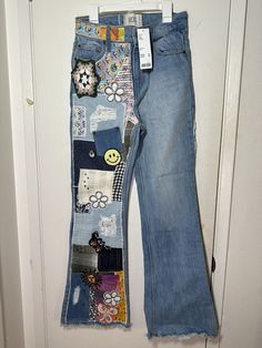 Add a unique touch to your wardrobe with these BDG Urban Outfitters women's patchwork studs flare jeans in size 24. The jeans are made of 100% cotton and feature a medium wash with belt loops and a button closure. The 5-pocket design includes fringe, embroidered, and sequin accents, making them a perfect choice for any occasion. The distressed details add a vintage feel to the straight style, which is perfect for any fashion-forward woman. The garment care instructions are dry clean only. Trendy Wide Leg Flare Jeans For Festival, Trendy Wide-leg Flare Jeans For Festivals, Festival Patchwork Denim Jeans, Cotton Flare Jeans With Wide Leg For Festival, Cotton Wide Leg Flare Jeans For Festival, Denim Blue Flare Jeans With Patchwork For Spring, Denim Blue Patchwork Flare Jeans For Spring, Trendy Straight Leg Patchwork Jeans, Spring Denim Blue Patchwork Flare Jeans