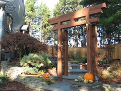 a wooden arbor with pumpkins on the steps