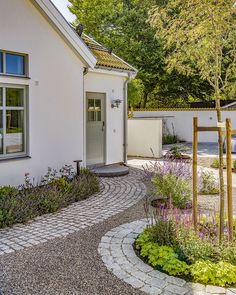 a white house with a stone path leading to the front door