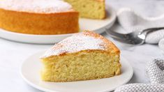 a piece of cake on a plate with a fork next to it and another slice in the background