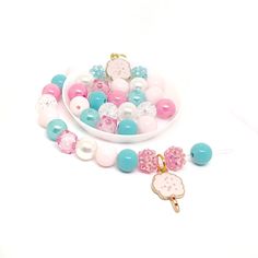 the necklace is decorated with pink, blue and white beads