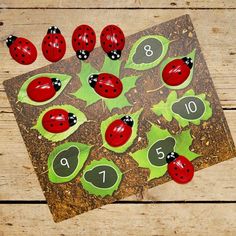 ladybugs and leaves are arranged in the shape of numbers on a piece of cardboard