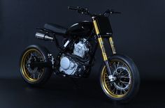 a black and gold motorcycle on a dark background