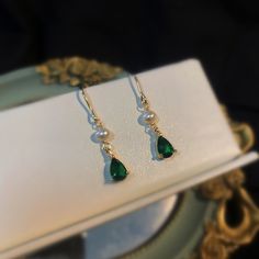 Introducing our stunning minimalist teardrop emerald gold and pearl drop earrings! Handcrafted with care and attention to detail, these earrings are the perfect blend of classic and modern style. The teardrop-shaped emerald gemstones are delicately set in 18k gold plated, giving these earrings an elegant and timeless look. The addition of the lustrous cultured pearls adds a touch of sophistication to these already stunning earrings. Measuring approximately 31mm in length, 5mm width, these earrin Elegant Pear-shaped May Birthstone Earrings, Elegant Teardrop May Birthstone Earrings, Classic Green Pearl Drop Earrings, Elegant Teardrop Earrings For May Birthstone, Elegant May Birthstone Teardrop Earrings, Green Teardrop Pearl Earrings For Wedding, Gold Pearl Drop Earrings For May Birthstone, Green Elegant Pearl Drop Earrings, Elegant Green Drop Pearl Earrings