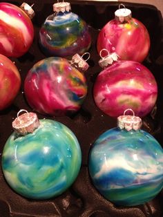 some colorful ornaments are in an egg carton