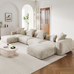 a living room with a large sectional couch and coffee table in the middle of it