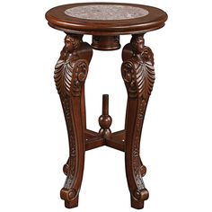 an ornate wooden table with marble top and carved carvings on the legs, isolated against a white background