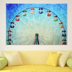 a painting of a ferris wheel on a wall above a couch