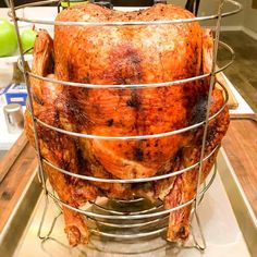 a whole turkey in a wire basket on a counter