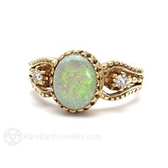 An absolutely gorgeous vintage inspired Australian Opal ring with diamonds in your choice of 14K or 18K White, Yellow or Rose Gold. This ring features a lovely natural Australian White Opal cabochon surrounded by a crown bezel. This is a solid natural opal, not a doublet. There are two natural diamonds, one on each side of the center stone, .16ctw. Stunning! Opal is a birthstone for October. Each Opal is a one of kind, so yours might differ slightly from the one shown, but it will be full or fir Garnet Ring Vintage, Opal Ring Vintage, Vintage Inspired Engagement Rings, Australian Opal Ring, Ruby Rings, Opal Ring Gold, Opal Engagement, Ruby Pendant, Emerald Pendant