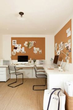 a home office with an orange wall and white desk