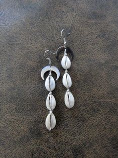 Long silver and cowrie shell earrings.  French hooks. Cowrie Shell Earrings, Cowrie Shell, Shell Earrings, Earrings Silver, Jewelry Earrings Dangle, Silver Earrings, Dangle Drop Earrings, Beauty Book, Shells