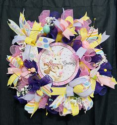 a wreath made out of different colored ribbons and bows with the words grandma's on it