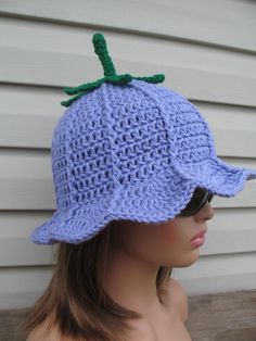 a mannequin wearing a blue crocheted hat