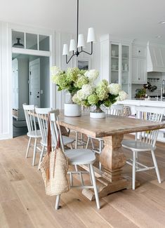 Coastal dining room with black chairs. Black windsor chairs and Serena & Lily Carson woven chairs complete this lake house dining area. Lake House Sofa, Lake House Dining Room Lighting, River House Living Room, Light Flooring Dining Room, Modern Lake House Dining Room, Natural Dining Room Ideas, Dining Room Light Floors, Coastal Grandma Dining Room, Lake House Dining Room Ideas