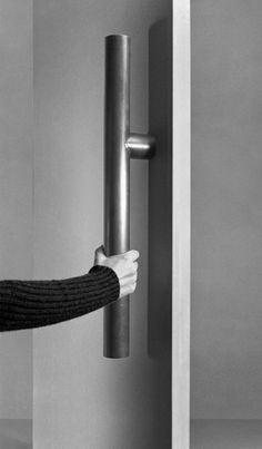 a woman is opening the door with her hand