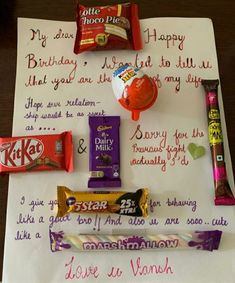 a birthday card with candy, chocolate bars and other items on it sitting on top of a piece of paper