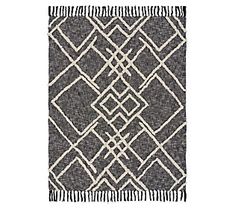 a gray and white rug with fringes