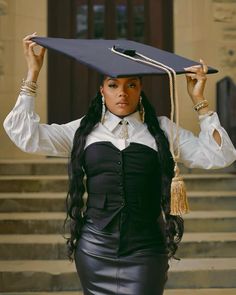 a woman with long hair wearing a graduation hat