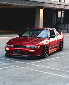 a red sports car parked in a parking lot