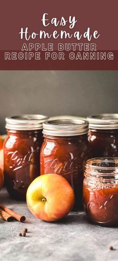 four jars filled with homemade apple butter and cinnamon on top of a table next to apples