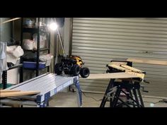 a motor bike is being worked on in a garage with tools and equipment around it