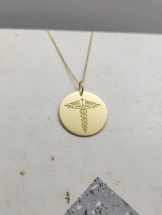 WE SHIP ALL PARCELS IN ONE BUSINESS DAY FOR FREE AND PROVIDE THE SPEEDIEST DELIVERY! Engraved Nurse Design Necklace - Medical Pendant Necklace - Handmade Nurse Gold Jewelry - Engraved Nurse Gold Necklace Engraved Nurse Pendant Necklace made out of 14K Solid Gold. Available only in Yellow Gold finish. An elegant piece of jewelry that is a perfect gift to yourself and your loved ones. Charm Thickness: 0.5mm Jump Ring inner diameter: 4mm Add your engraved personalization at the back of the pendant. Customizable 14k Gold Pendant Necklace, Customizable 14k Yellow Gold Necklaces, Customizable 14k Yellow Gold Necklace, Customizable Yellow Gold Anniversary Necklace, Symbolic 14k Gold Necklaces Stamped 14k, Customizable Yellow Gold Round Pendant Jewelry, Customizable Yellow Gold Round Pendant Necklace, Customizable Yellow Gold Round Pendant, Yellow Gold Round Necklace With Hallmark