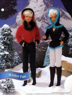 two barbie dolls standing next to each other in front of snow covered mountains and trees