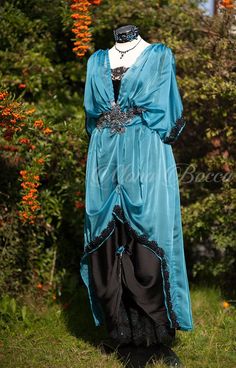 a dress on display in front of some bushes