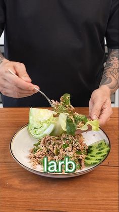 a man is cutting up lettuce on top of a plate with the word labb written on it