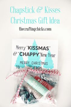 merry kissmas and happy new year candy bag with christmas tags on the front, wrapped in red and white twine