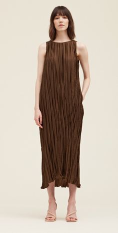 This pleated midi is such a gorgeous rich color. This simple silhouette is elevated with the beautiful pleated fabric with a little sheen and features pockets and a tie at the waist. Fabric & Care 100% Polyester Hand wash, Hang to dry Sizing True to size, relaxed fit. Brown Midi Dress, Blouse Tank Top, Pleated Maxi, Pleated Maxi Dress, Maxi Dress Cocktail, Pleated Fabric, Pleated Midi Dress, Long Sweaters, Long Maxi Dress