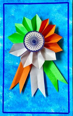 an origami flower on a blue background with the word india written below it