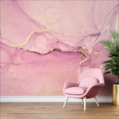 a pink chair sitting in front of a wall with a painting on it's side